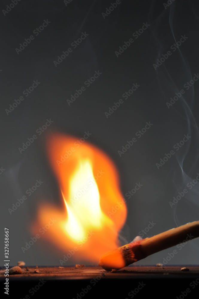 Matchstick ignites with the help of the matchbox with beautiful flames and smoke. Matchstick ignites with the help of the matchbox with beautiful flames and smoke.