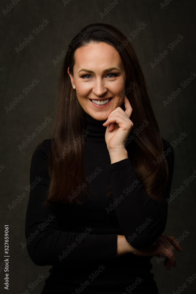 Dramatic portrait of a brunette woman on dark background Dramatic portrait of a brunette woman on dark background