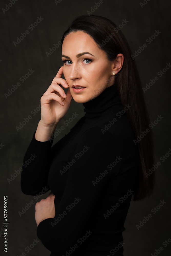 Dramatic portrait of a brunette woman on dark background Dramatic portrait of a brunette woman on dark background