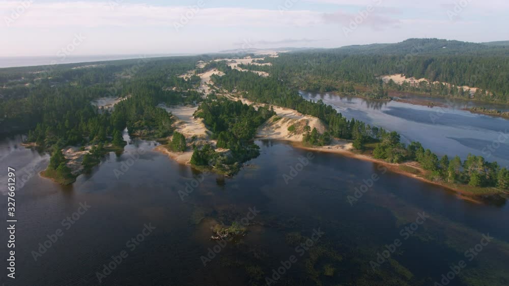 Oregon Coast circa-2019. Aerial view of sand dunes on Oregon Coast. Shot from helicopter with cineflex gimal and RED 8K camera. Oregon Coast circa-2019. Aerial view of sand dunes on Oregon Coast. Shot from helicopter with cineflex gimal and RED 8K camera.