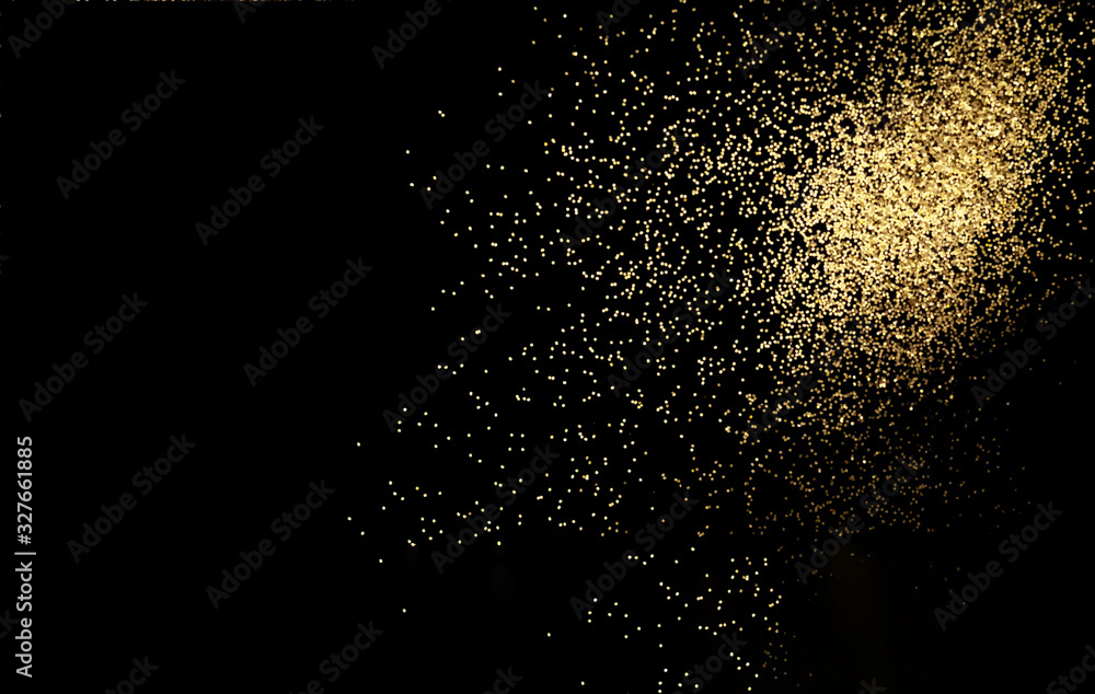 Black background with golden sparkles. Blurred effect. Concept for festive background