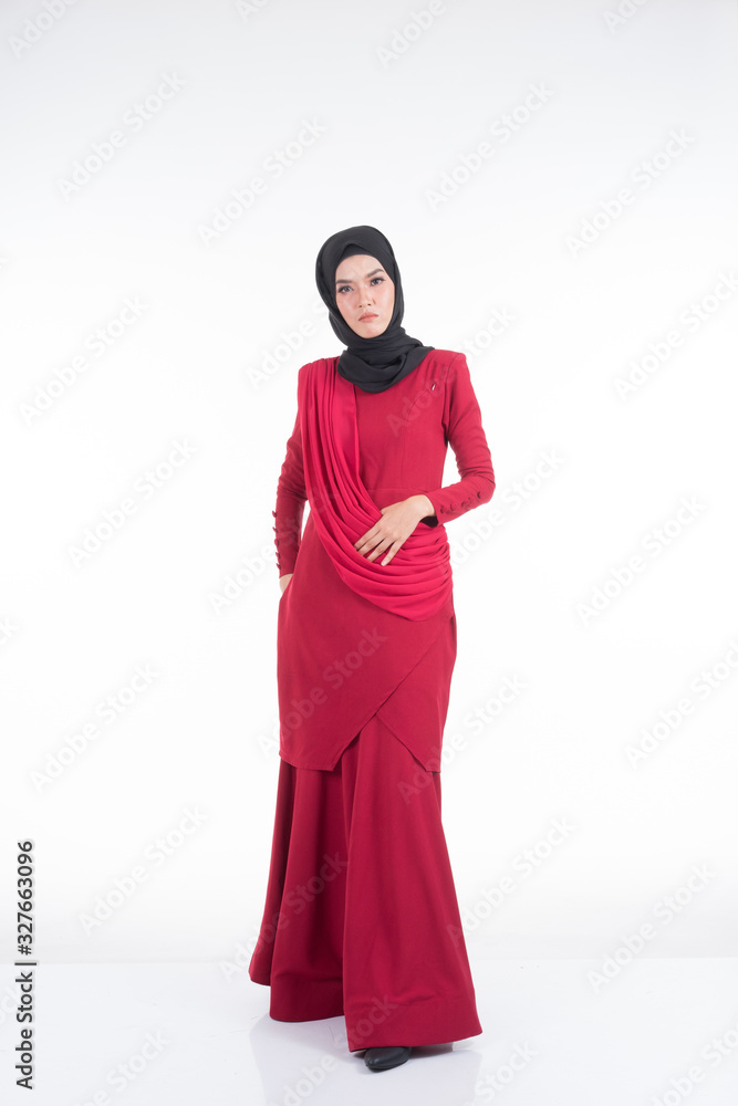 Beautiful female Asian model in various poses wearing a red Malaysian traditional wear isolated on white background. Beauty and fashion concept. Full length portrait Beautiful female Asian model in various poses wearing a red Malaysian traditional wear isolated on white background. Beauty and fashion concept. Full length portrait
