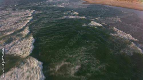 Oregon Coast circa-2019.  Aerial view of waves and beach.  Shot from helicopter with cineflex gimal and RED 8K camera. photo