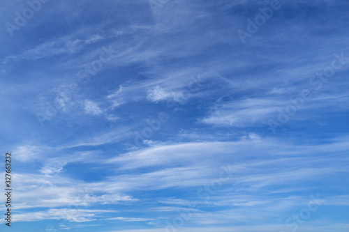 Bright beautiful blue sky with soft clouds for background or texture