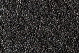 Foam rubber texture close up. High quality macro texture of dark grey paralon sponge.