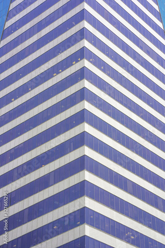 Abstract architecture. Glass blue square Windows of facade modern city business building skyscraper. The texture of the windows of the building.  
