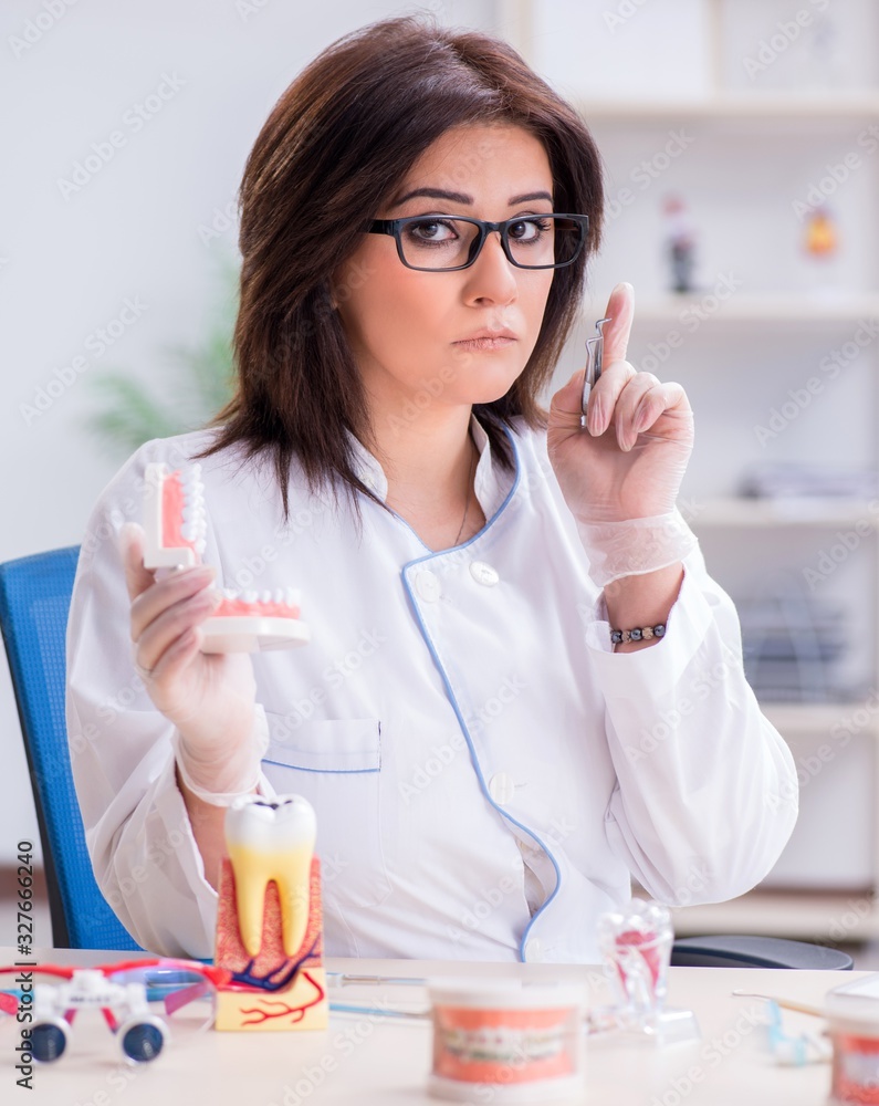 Woman dentist working on teeth implant Woman dentist working on teeth implant