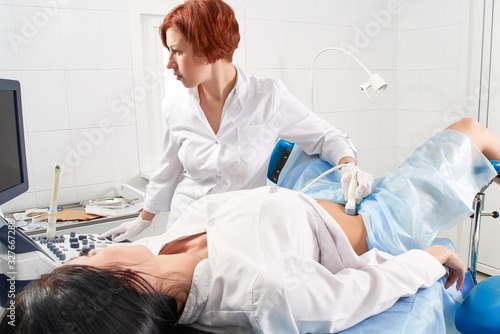 Gynecologist doing ultrasound scanning  photo