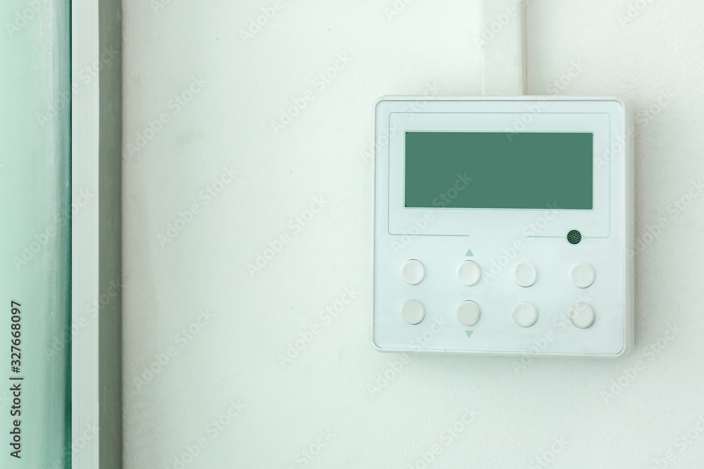 white wall air conditioning control panel with screen and control buttons, close up empty. white wall air conditioning control panel with screen and control buttons, close up empty.
