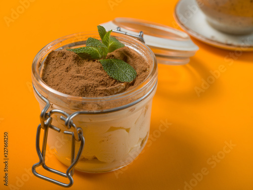 Sweet cold dessert with tea on a colored background