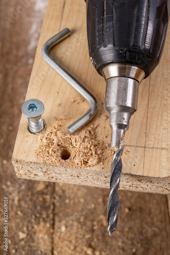 Tools and screws used in carpentry. Small carpentry work in the workshop. photo