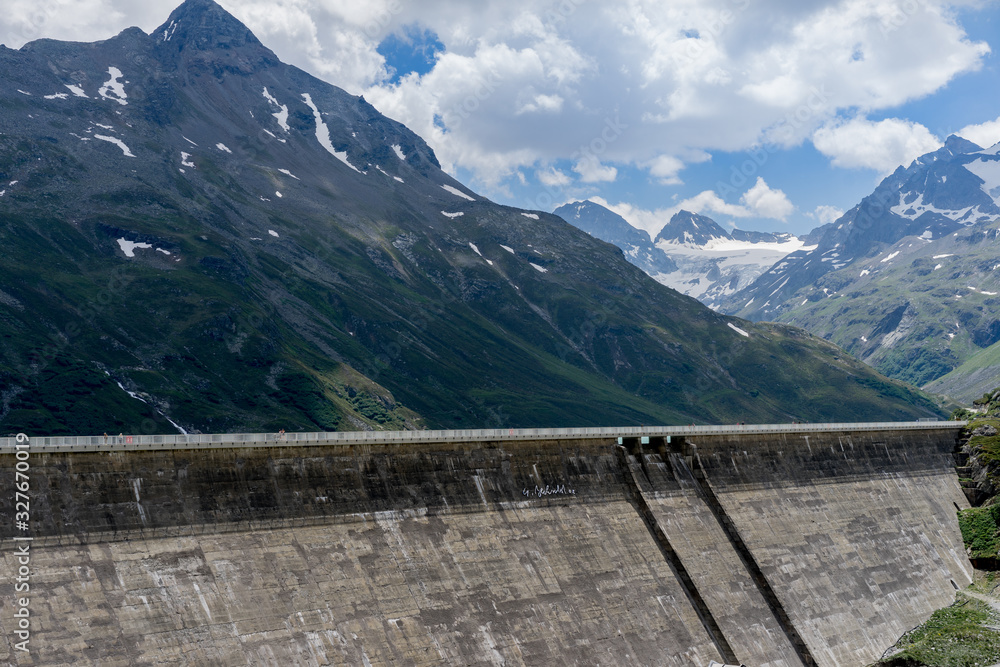 A big wall is surounding a lake in the alps of Vorarlberg, Austria.