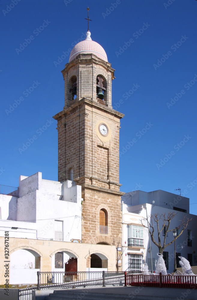 Historical city gate with clock tower in the old town of Chiclana de la Frontera, Andalusia in Spain