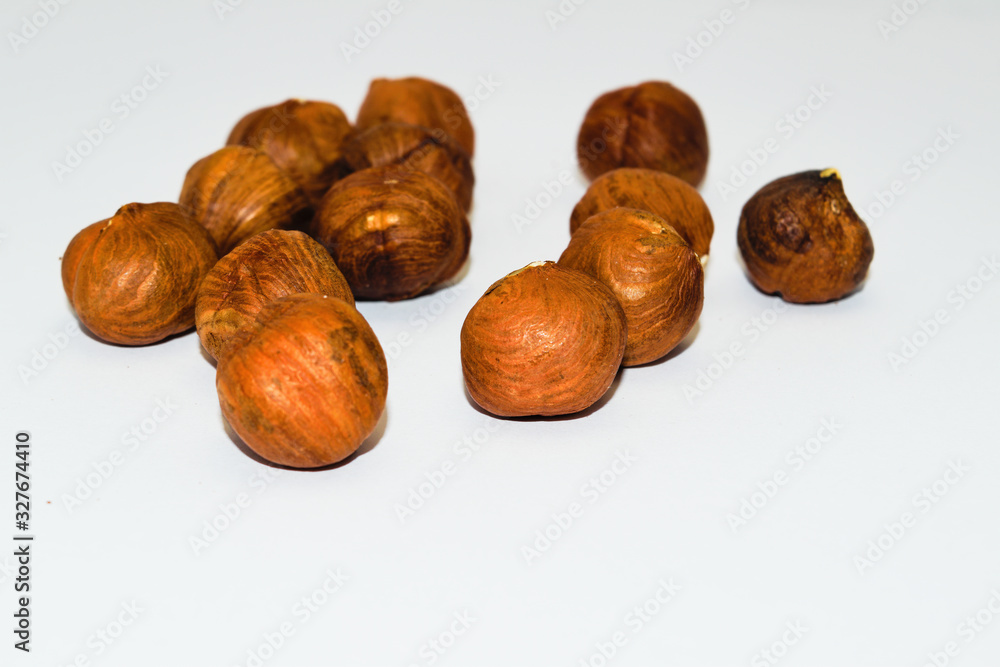 Peeled hazelnuts close-up isolate on a white background. Peeled hazelnuts close-up isolate on a white background.