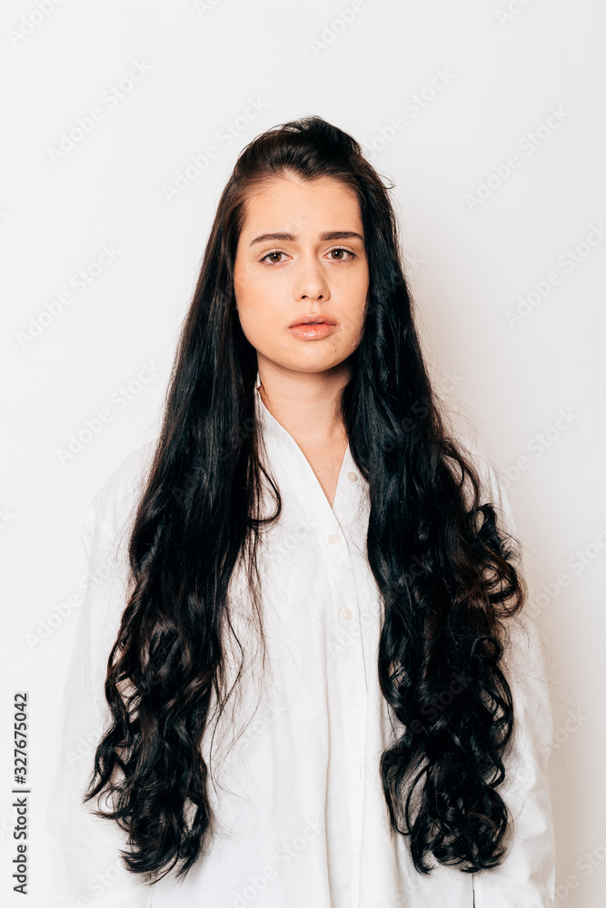 portrait of a beautiful young woman with long black hair on white background portrait of a beautiful young woman with long black hair on white background
