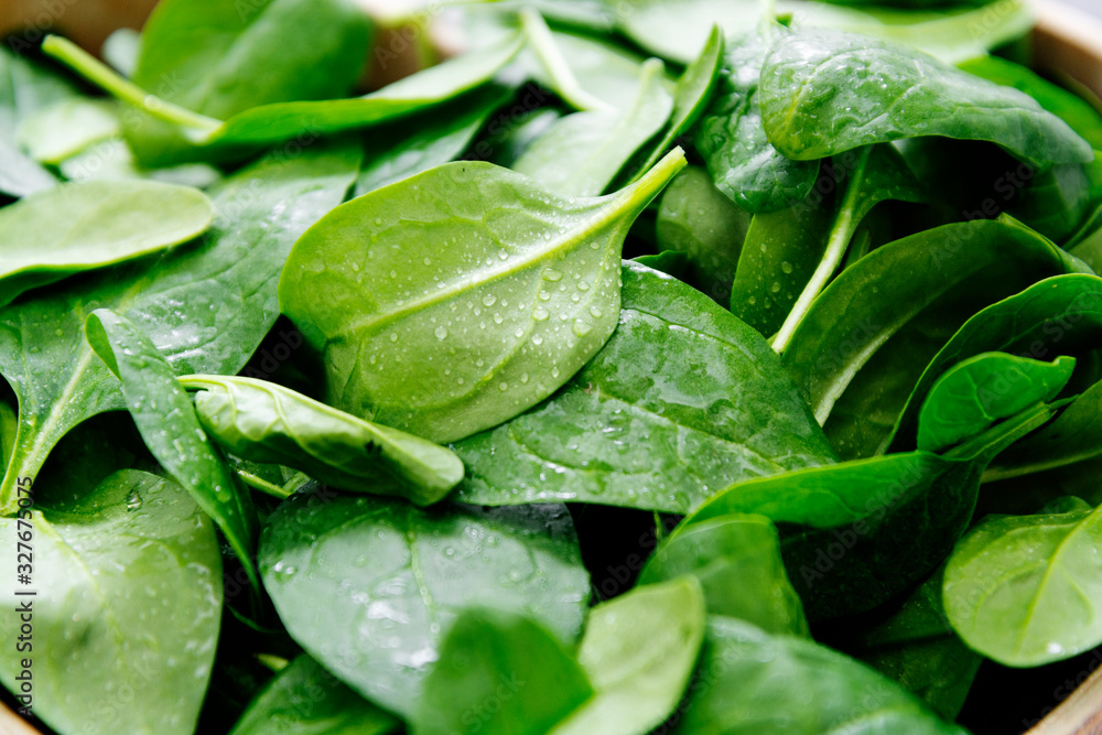 Fototapeta premium Fresh spinach leaves or spinach salad close up, background