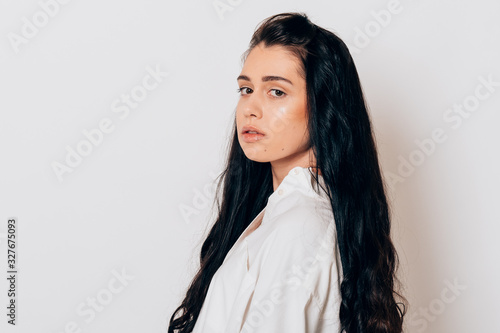 portrait of a beautiful young woman with long black hair on white background