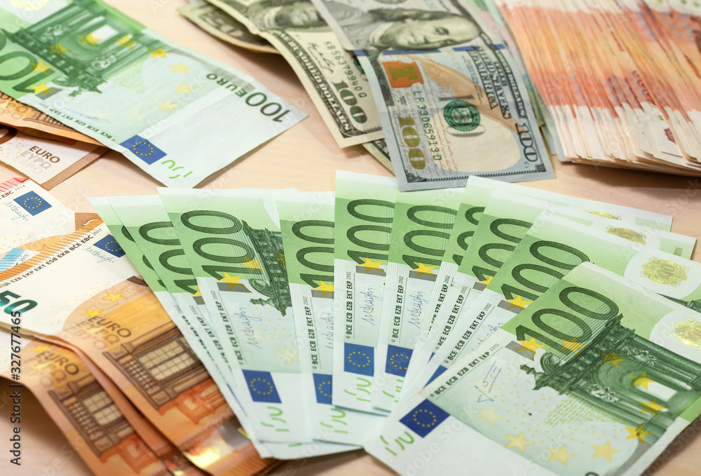 Heap of green houndred euro banknotes on the table Heap of green houndred euro banknotes on the table