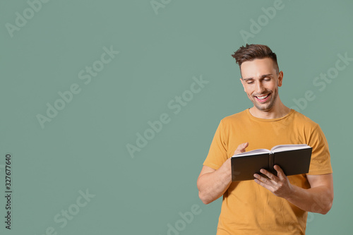 Happy man reading book on c...