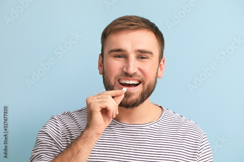 Young man with chewing gum ...