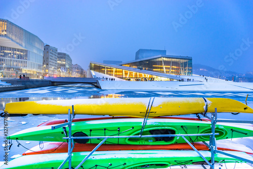 National Oslo Opera House with colourful kayaks on the foreground after dusk. Oslo Opera House was opened on April 12, 2008 in Oslo, Norway