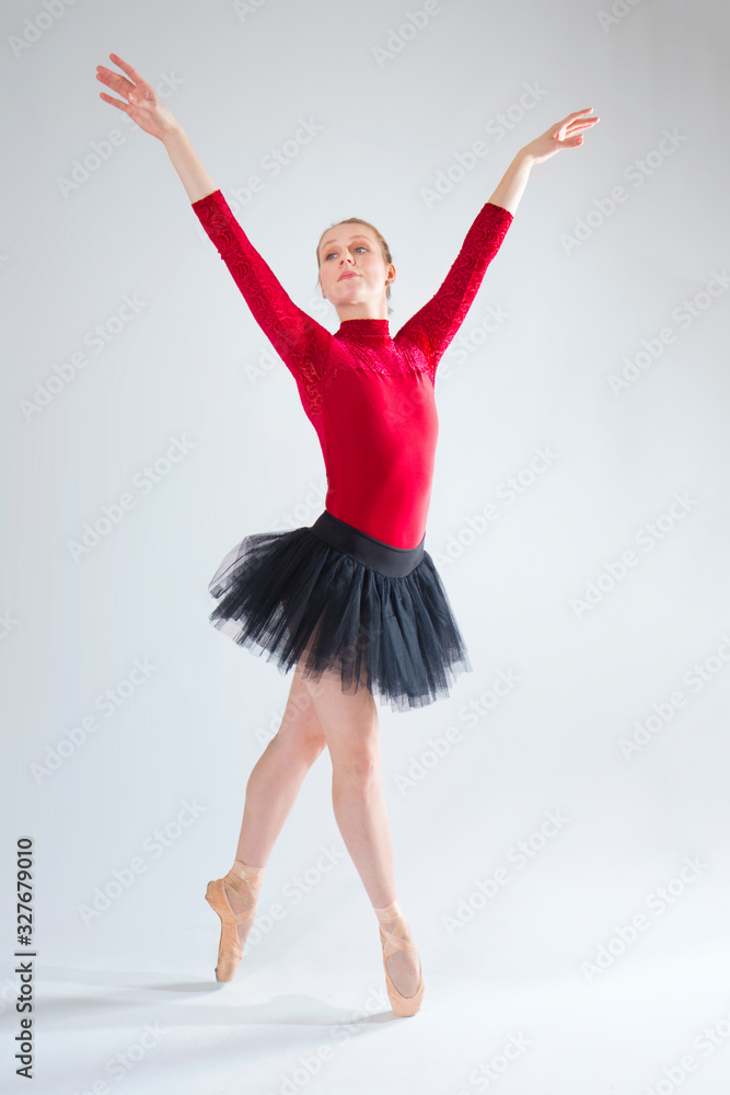 Young woman ballet dancer in red leotard and black tutu. Young woman ballet dancer in red leotard and black tutu.