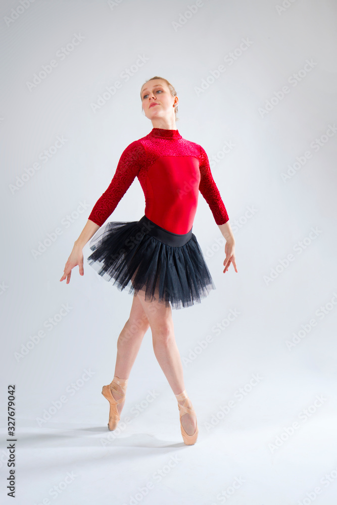 Young woman ballet dancer in red leotard and black tutu. Young woman ballet dancer in red leotard and black tutu.