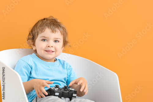 Cute little boy with game p...