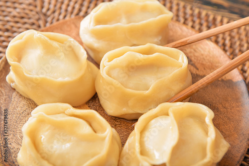 Eating of tasty oriental dumplings, closeup