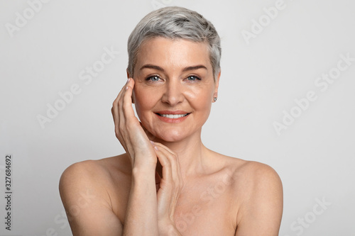 Nude Portrait Of Beautiful Mature Woman Over Light Background, Closeup