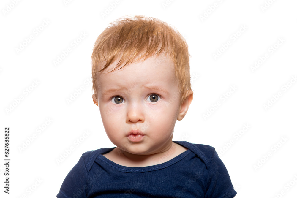 Portret of a surprised child with wide eyes from unexpected emotions, redhead toddler isolated on a white background.