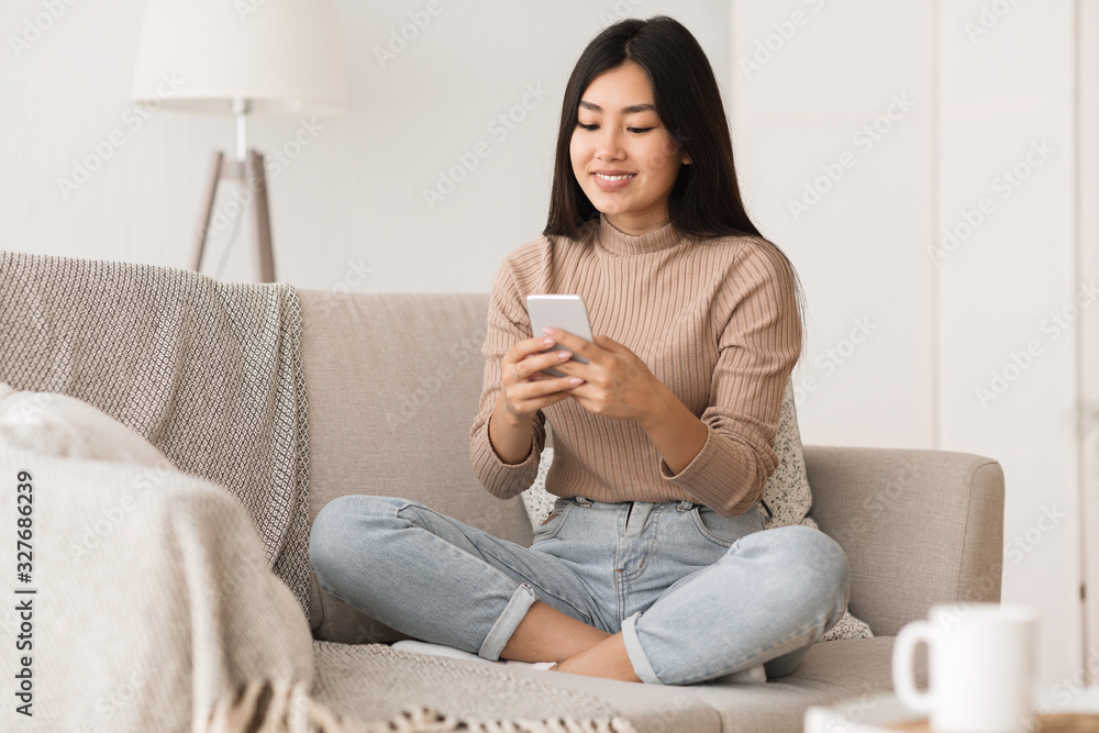 Cheerful girl texting on smartphone, enjoying weekend Cheerful girl texting on smartphone, enjoying weekend