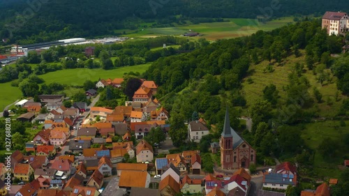 Aerial view of the  village and castle Gamburg in Germany. Pan to the left beside the village revealing the castle. photo