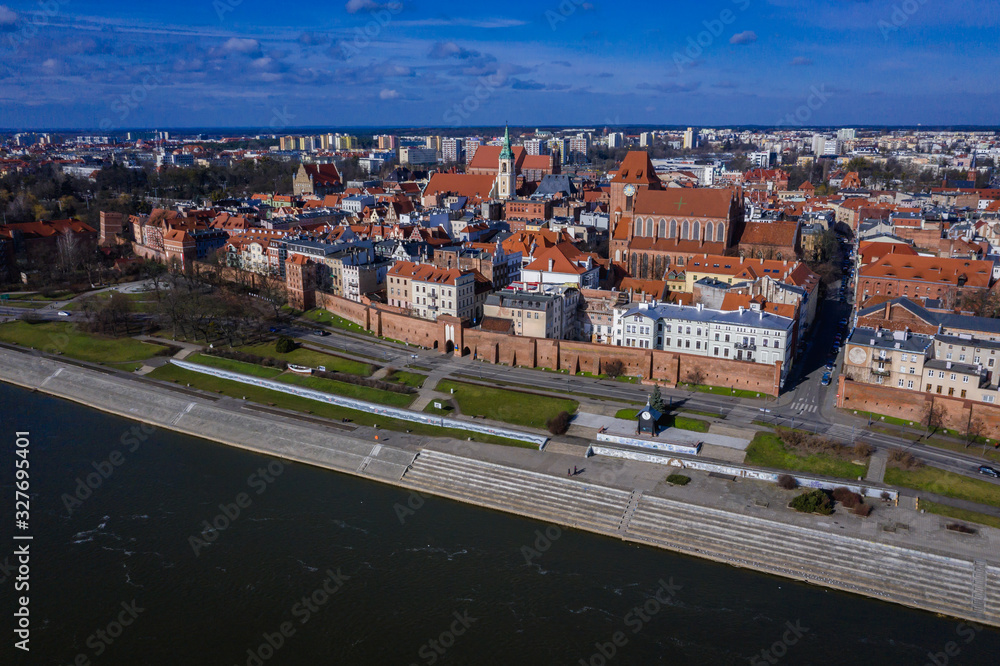 Drone view of historic part of Torun city over Vistula River in Poland with St John the Baptist Cathedral and Church of Holy Spirit