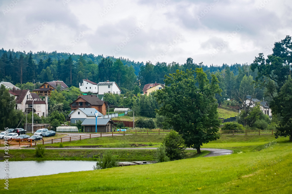 A view from above on a panorama of cottages by the river. Mountain landscape A view from above on a panorama of cottages by the river. Mountain landscape