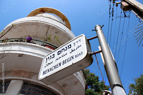 Bauhaus style Bauhaus on the street corner. Sign with the name of the street Menachem Begin Road. Tel Aviv, Israel. photo