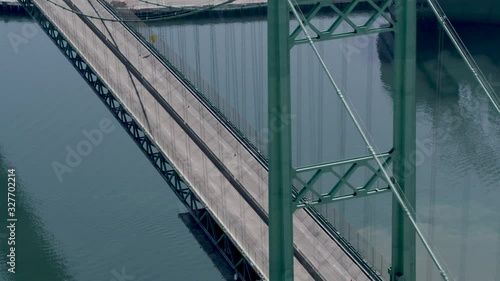 Aerial, car drives on Vincent Thomas Bridge in California