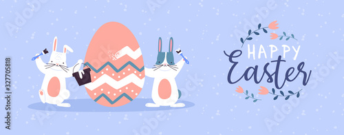 Happy easter card of funny rabbits painting egg