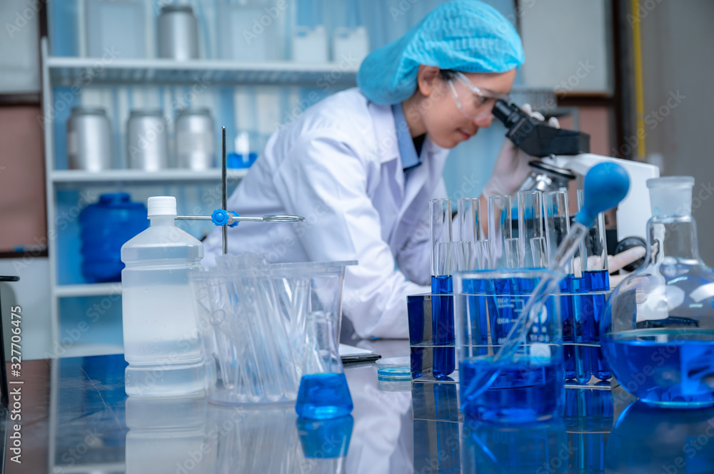 Science and medicine, scientist analyzing and dropping a sample into a glassware, experiments containing chemical liquid in laboratory on glassware, DNA structure, innovative and technology. Science and medicine, scientist analyzing and dropping a sample into a glassware, experiments containing chemical liquid in laboratory on glassware, DNA structure, innovative and technology.