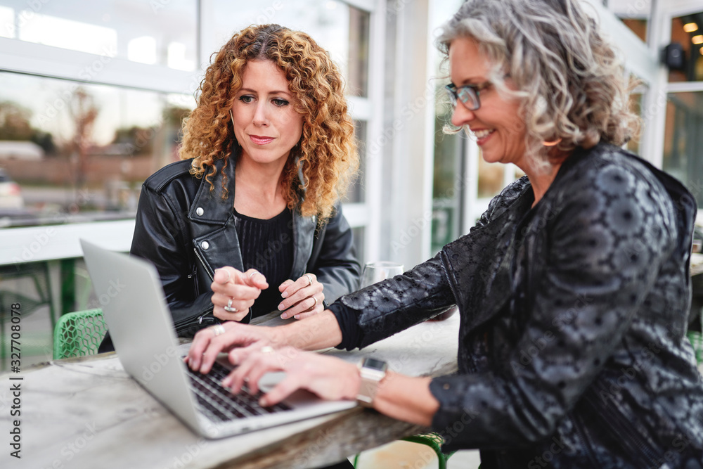 two businesswomen having a meeting outside two businesswomen having a meeting outside