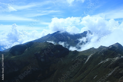 A empty mountain ridge in the andes with a stunning cloudscape and bright blue sky