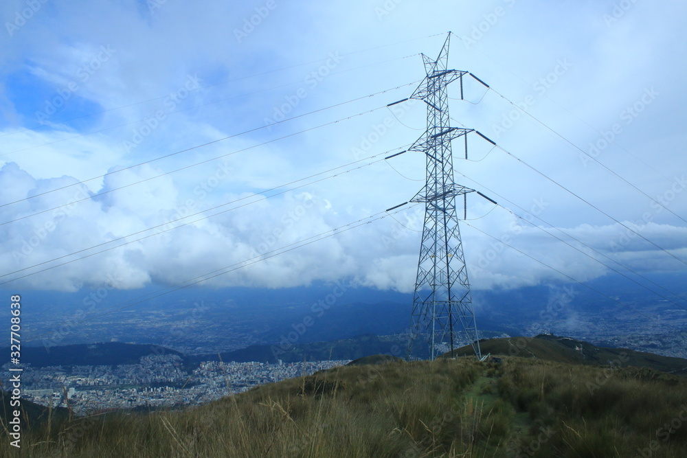 An electricity pole on the very top of the mountain near quito with all electricity lines running downwards An electricity pole on the very top of the mountain near quito with all electricity lines running downwards