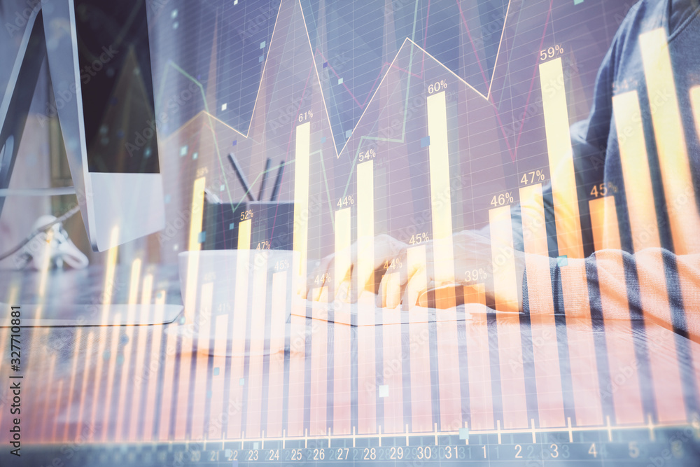 Multi exposure of graph with man typing on computer in office on background. Concept of hard work. Multi exposure of graph with man typing on computer in office on background. Concept of hard work.