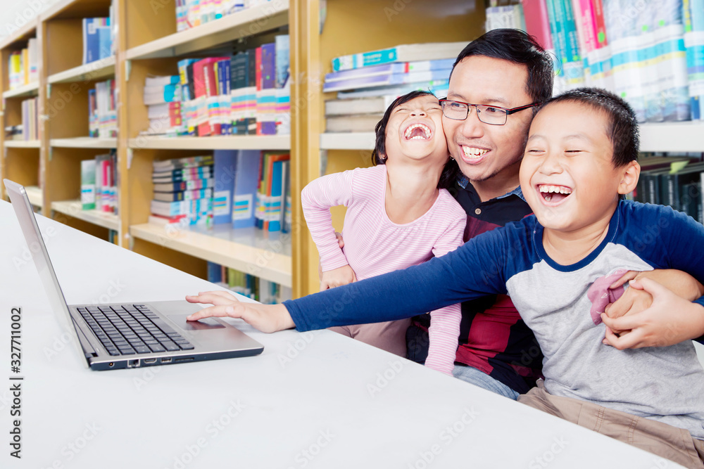 Children cheering while being guided in a library Children cheering while being guided in a library