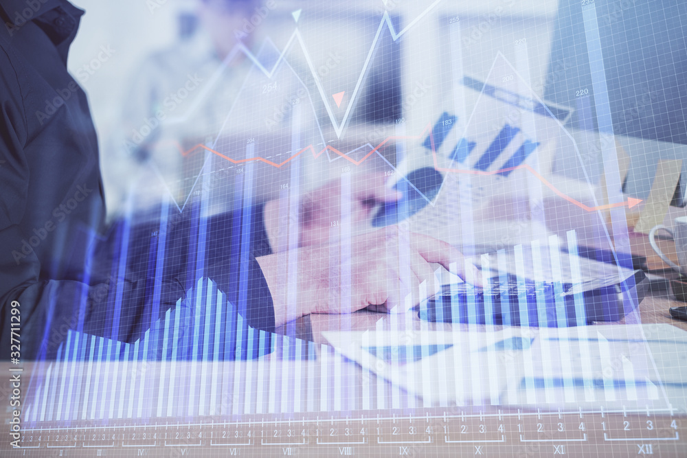 Double exposure of graph with man typing on computer in office on background. Concept of hard work. Closeup. Double exposure of graph with man typing on computer in office on background. Concept of hard work. Closeup.