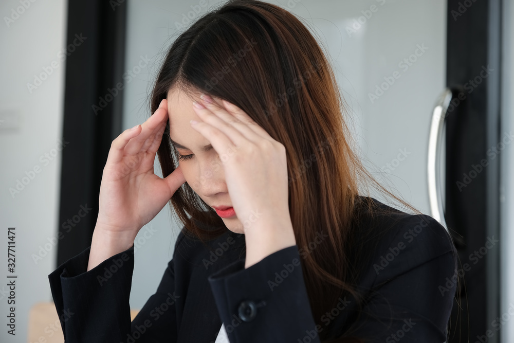 Female employees show headaches from work or disappointment from work. Health and care concept
