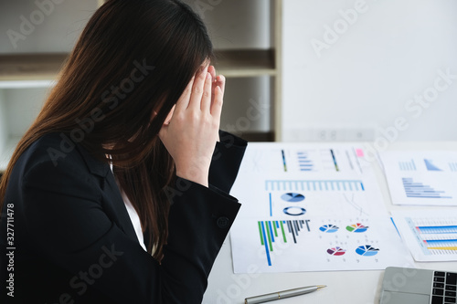 Female employees show headaches from work or disappointment from work. Health and care concept photo