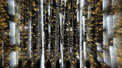 Colorful running bokeh lights in the New Year or Christmas fountain yellow and white night illumination