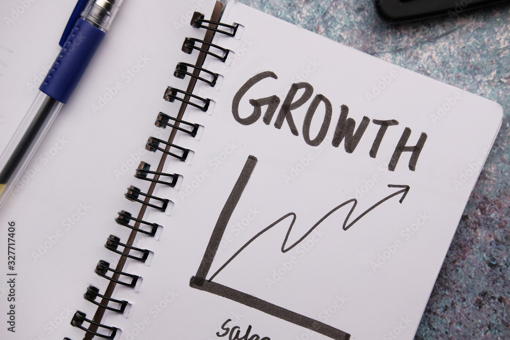 growth chart on notepad with pen on table growth chart on notepad with pen on table