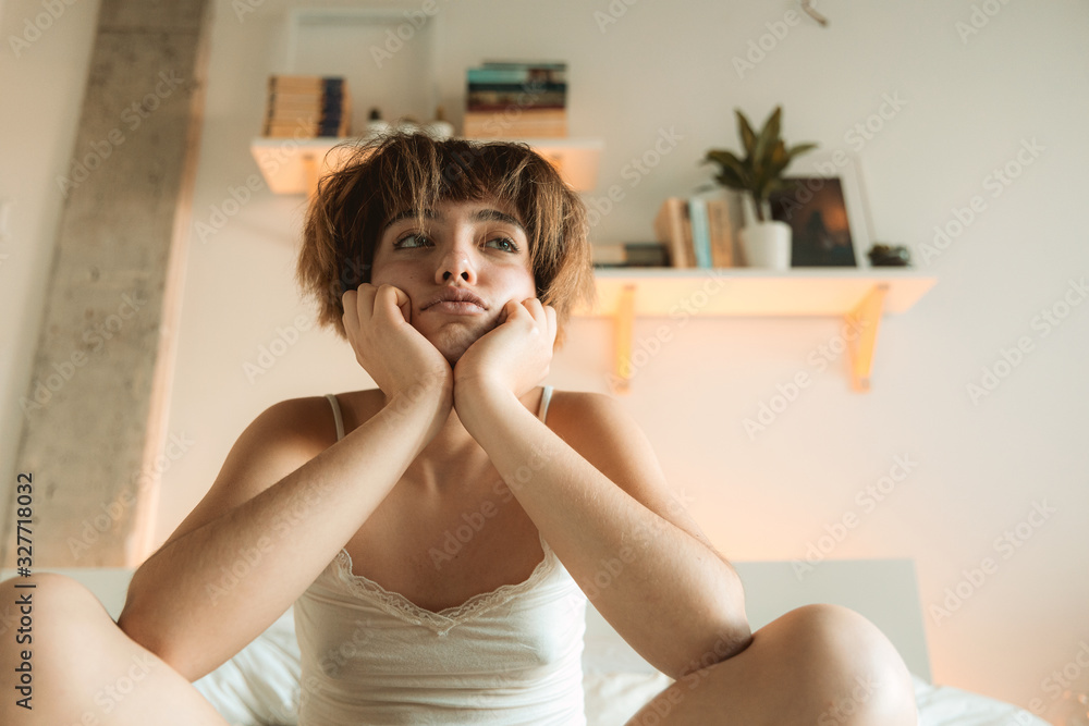 Naklejka premium Young woman wakes up confot at home monday morning